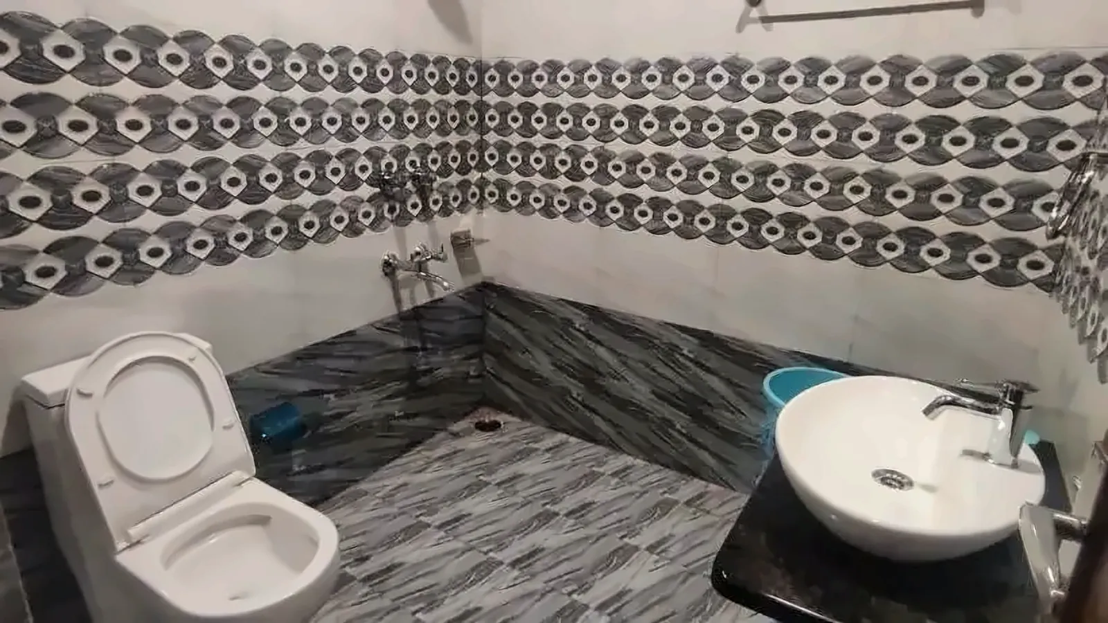 Private bathroom with a washbasin, toilet and shower area